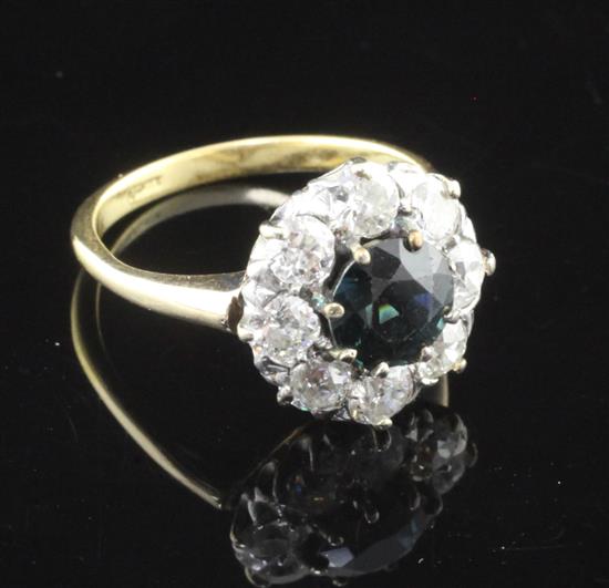 An 18ct gold, sapphire and eight stone diamond cluster ring, size M.